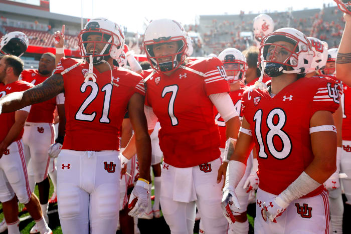 Utah Utes quarterback Cameron Rising (7), center, celebrates with his teammates after their win against the Washington State Cougars.